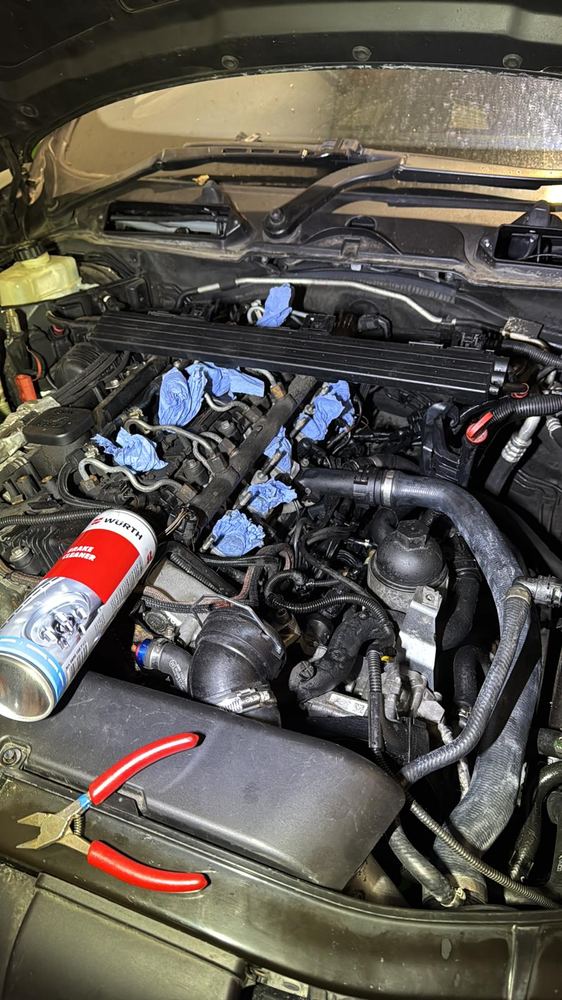 Engine bay work during the 335D restoration.
