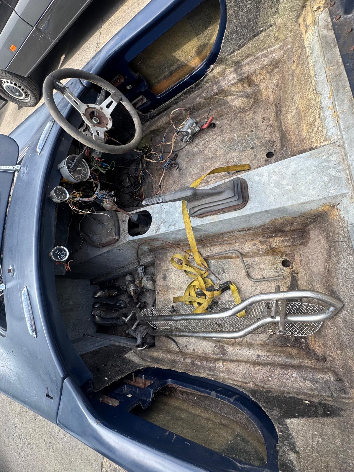 Interior strip-down revealing the original cockpit and controls.